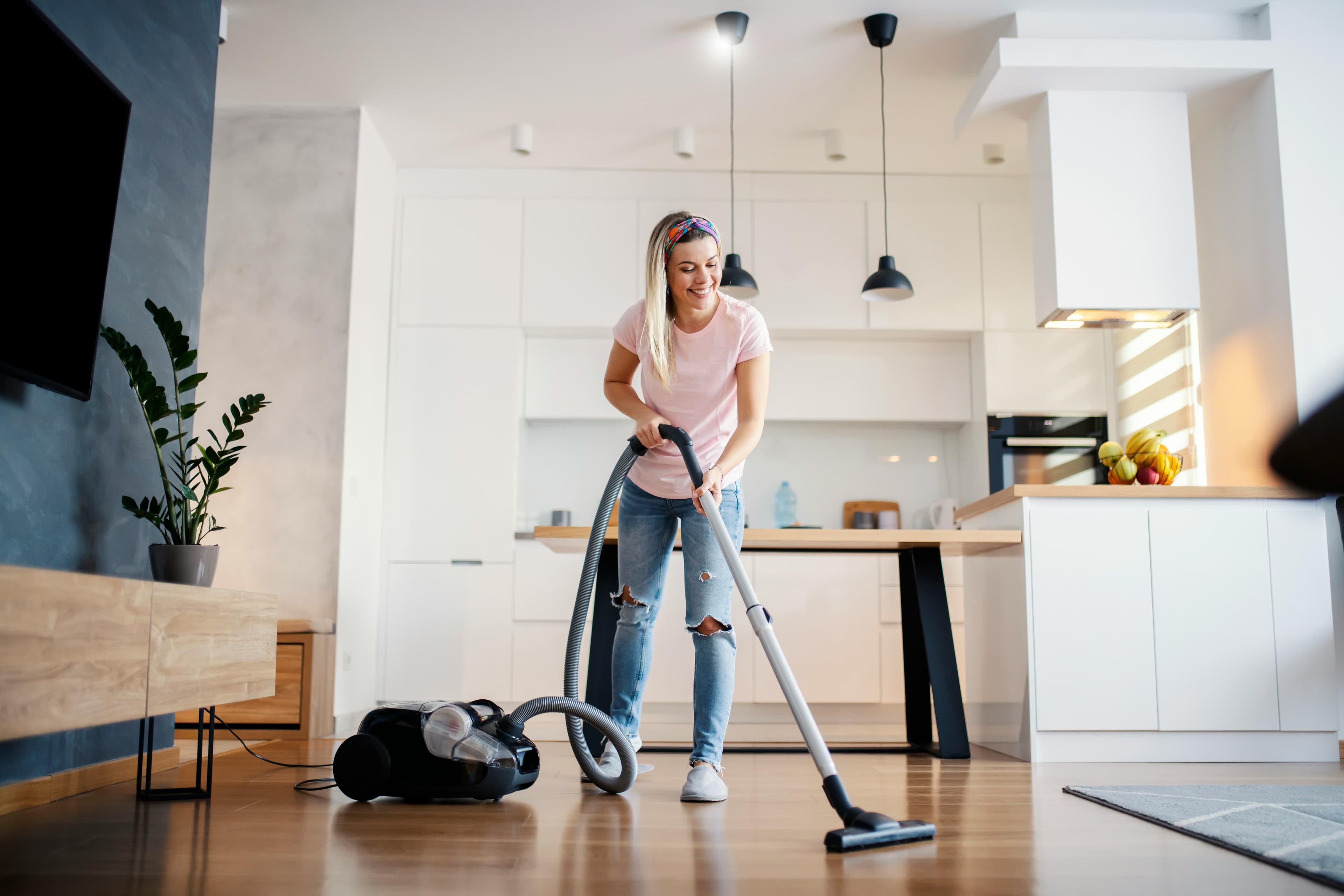 Professional cleaner mopping a bright modern floor